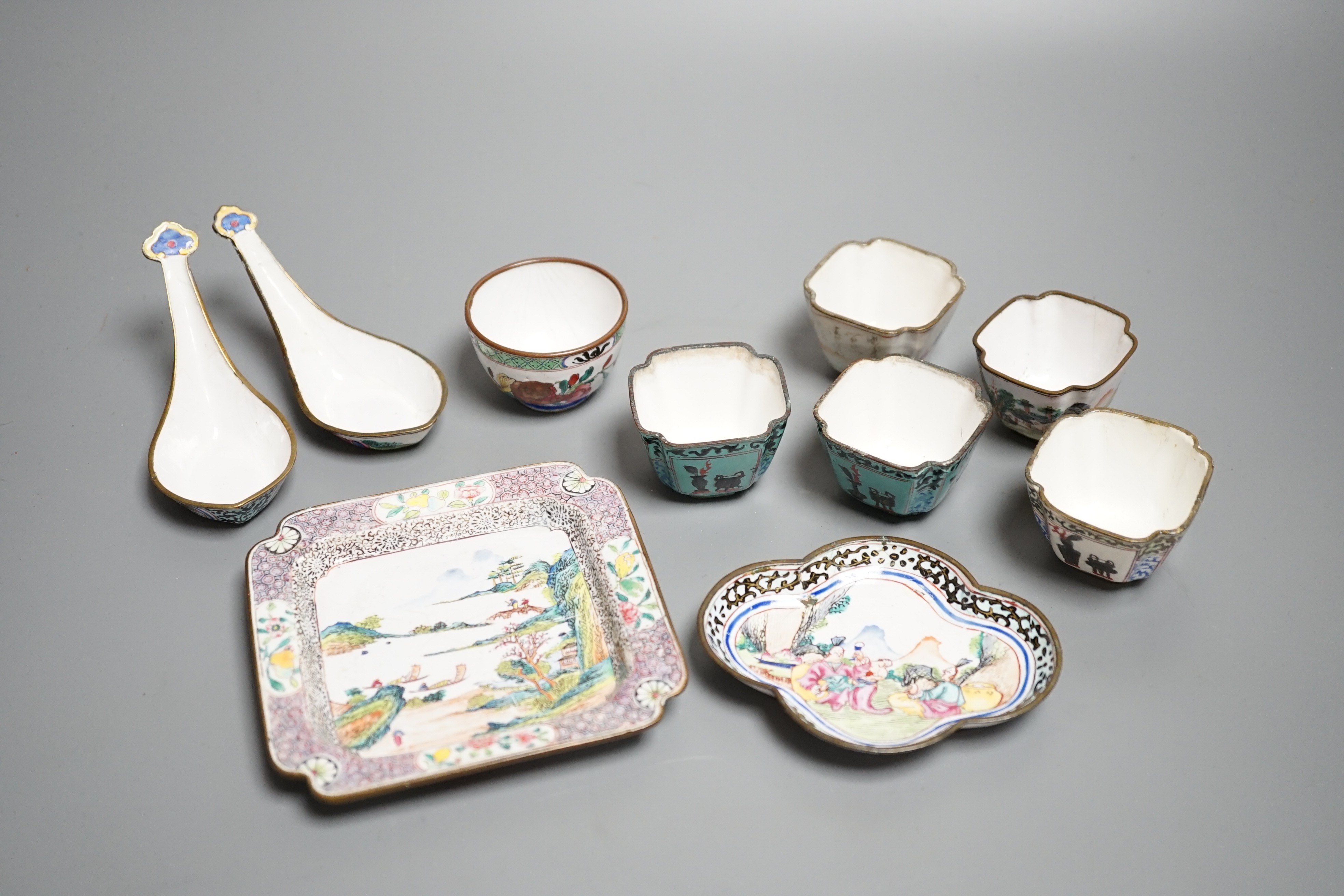 Nine pieces of Chinese Canton enamel wares, Qianlong period, including two enamel dishes, two rice spoons, and six various cups, largest 11cm